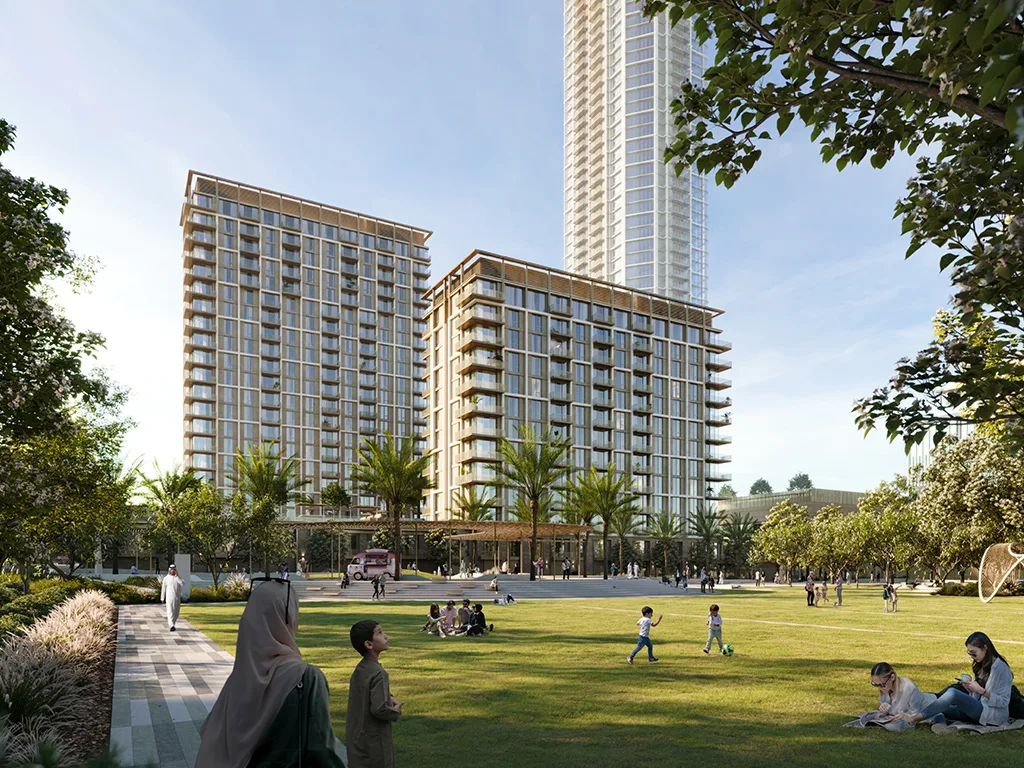 Aeon at Dubai Creek Harbour — daylight official still of both mid-rise towers across a park lawn