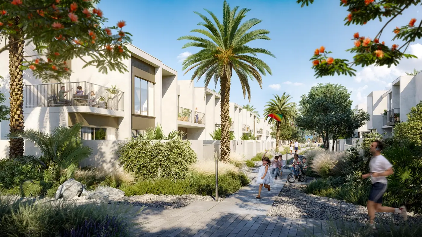 Alva 2 at The Valley — street-level marketing still of townhouse façades, palms and a landscaped pedestrian path