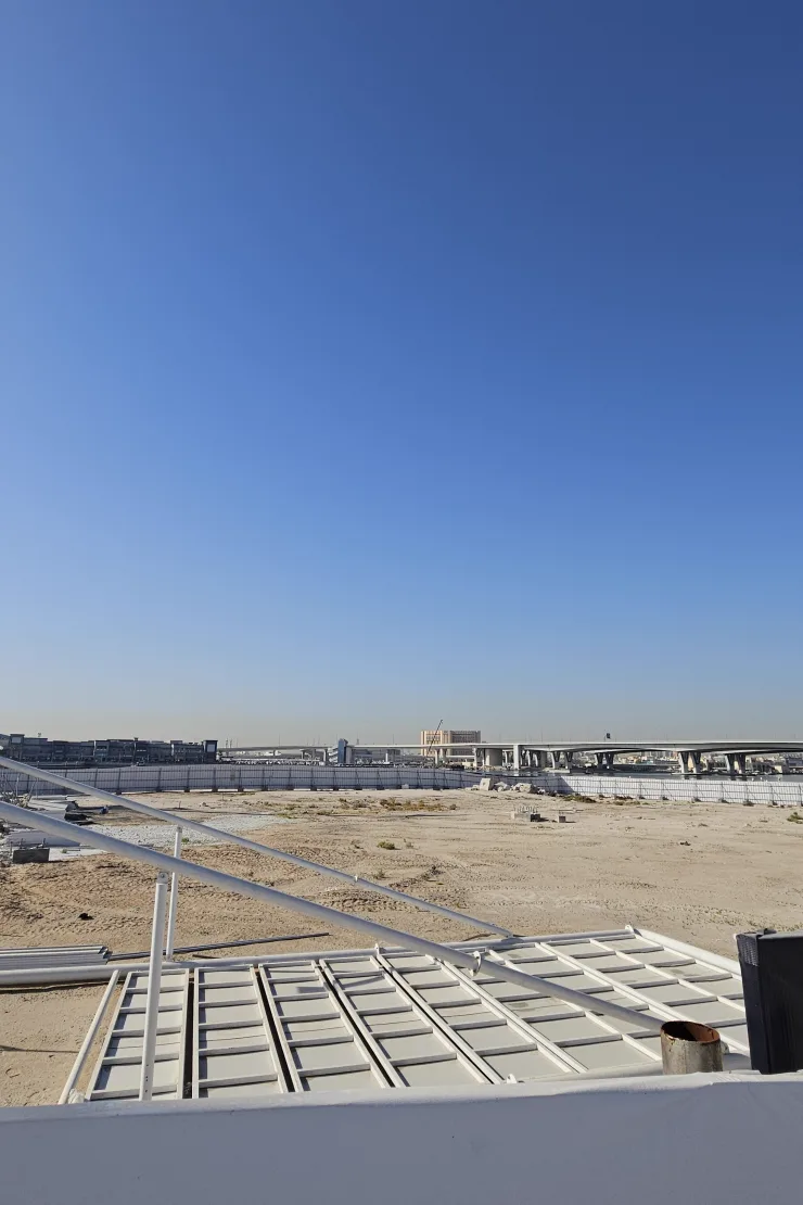 Azizi Wasel — May 2026 Propsearch site photo of a vacant hoarded plot, not a standing tower
