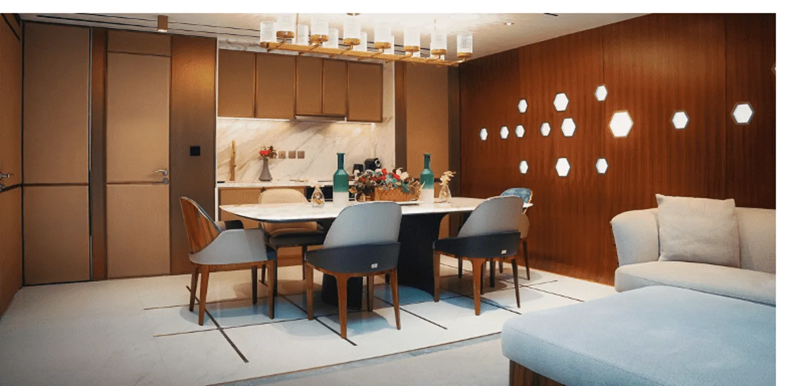 Buddha-Bar Hotel and Floating Residences — press-kit dining interior with marble table, timber wall and hexagonal lights