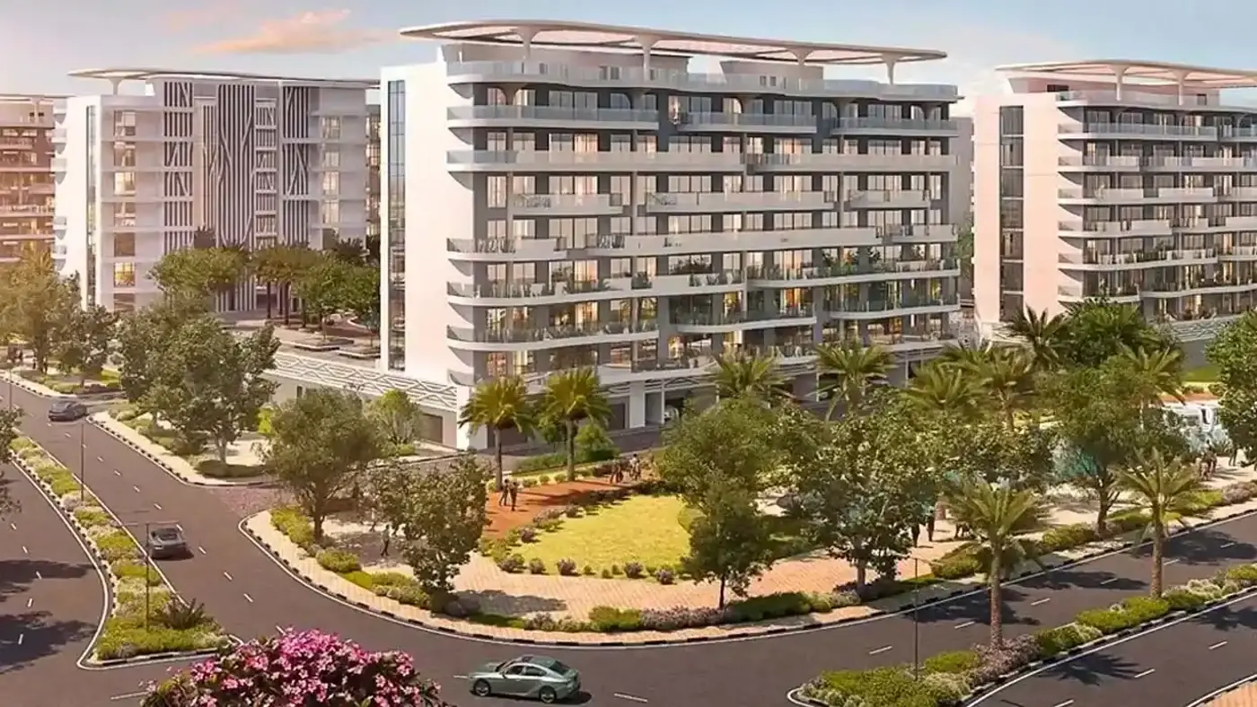 Cetara at DAMAC Lagoons — broker marketing still of white mid-rise apartment blocks with slatted roof crowns on a landscaped street