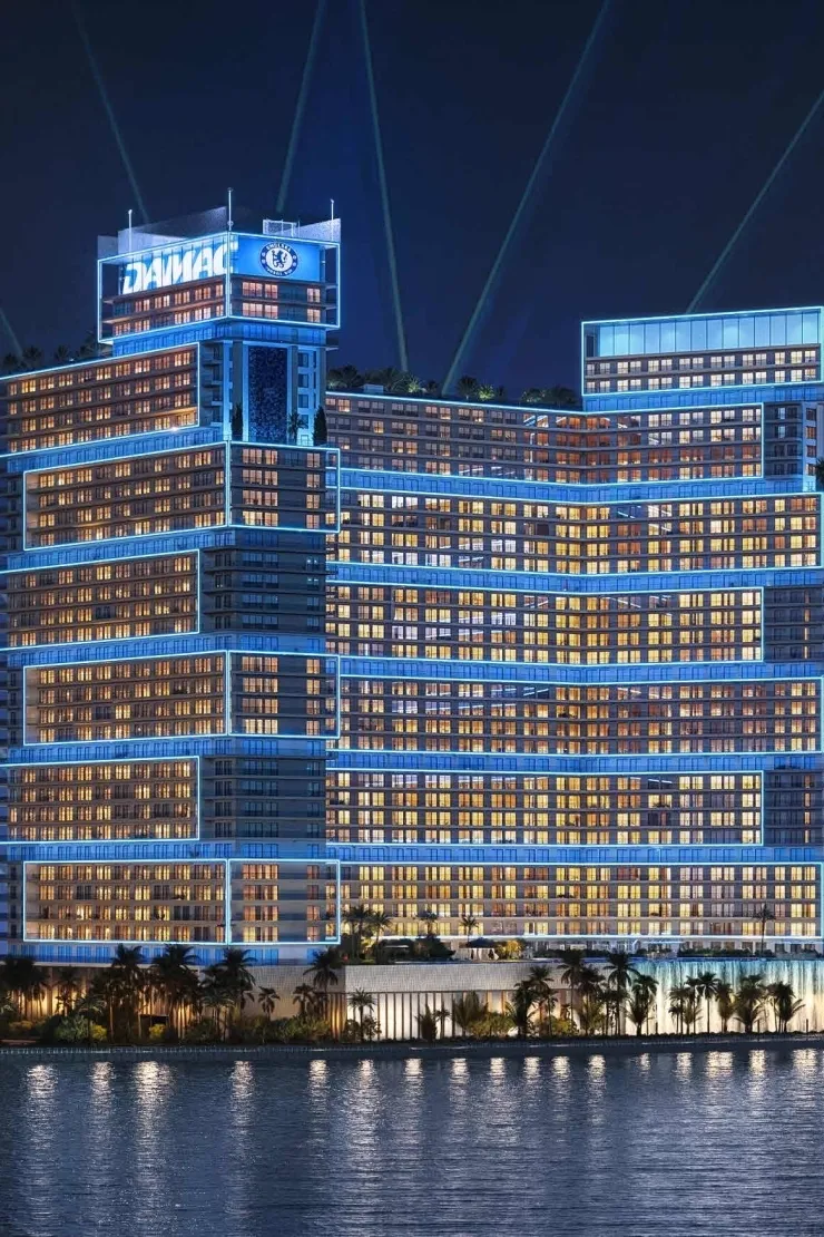 Chelsea Residences 2 — night exterior marketing still with DAMAC and Chelsea FC crest lighting