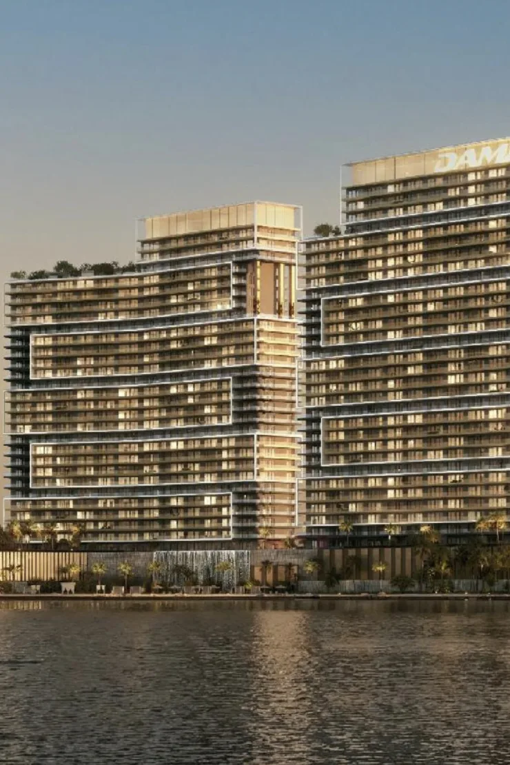 Propsearch Seacrest Resort Residences still — close waterfront crop of two stepped towers with a DAMAC crown