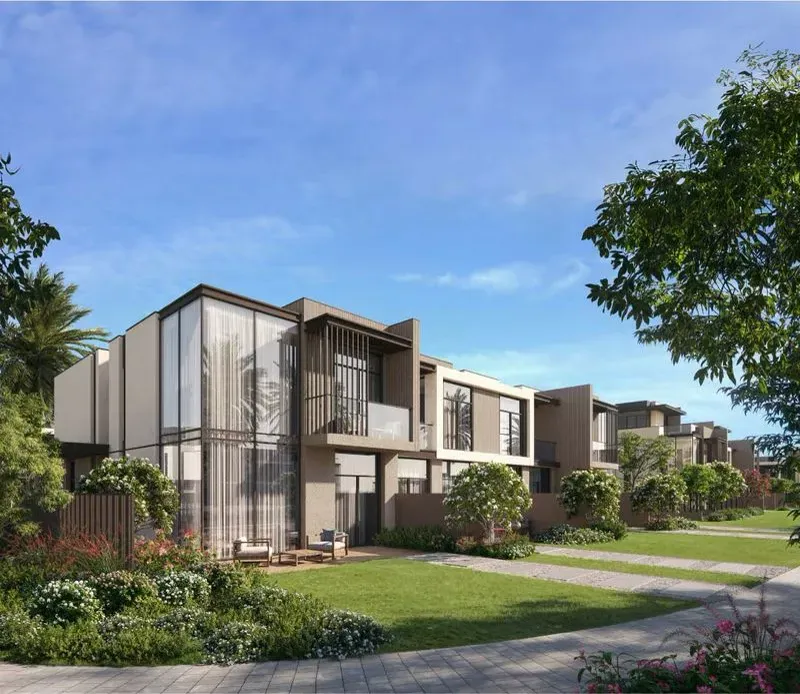 Official La Tilia daytime street row of G+2 beige townhouses with a glass corner