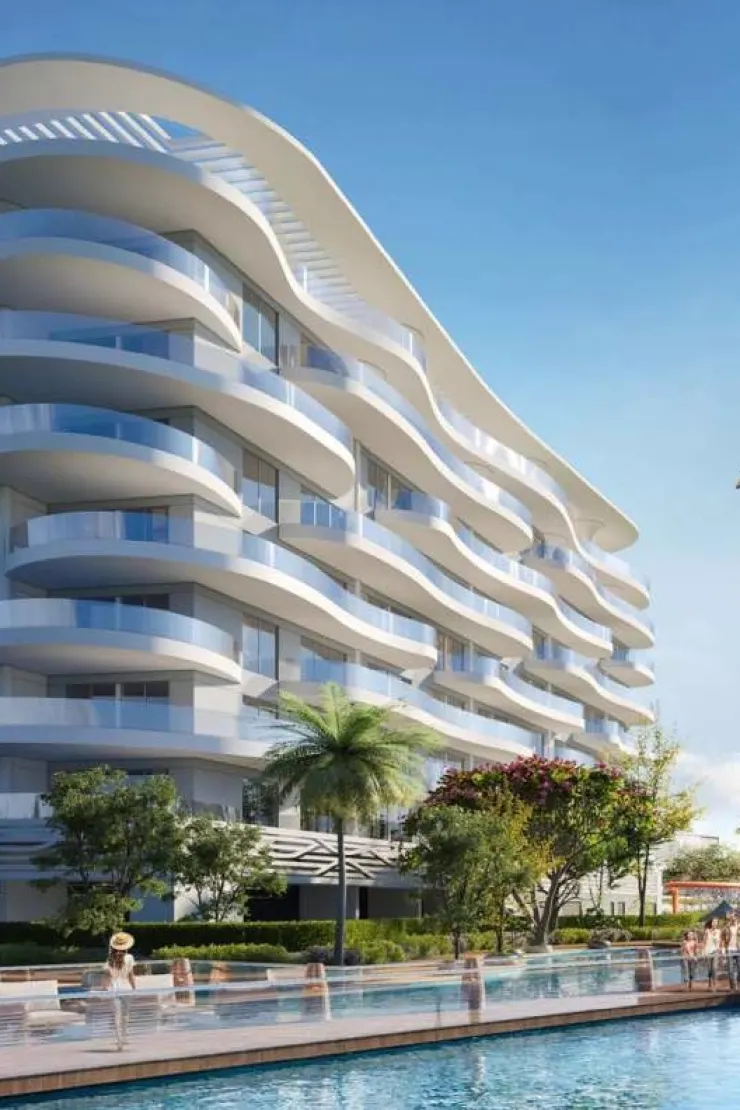 Lagoon Views 11 at DAMAC Lagoons — marketing close exterior of white curved balcony façades beside a pool deck