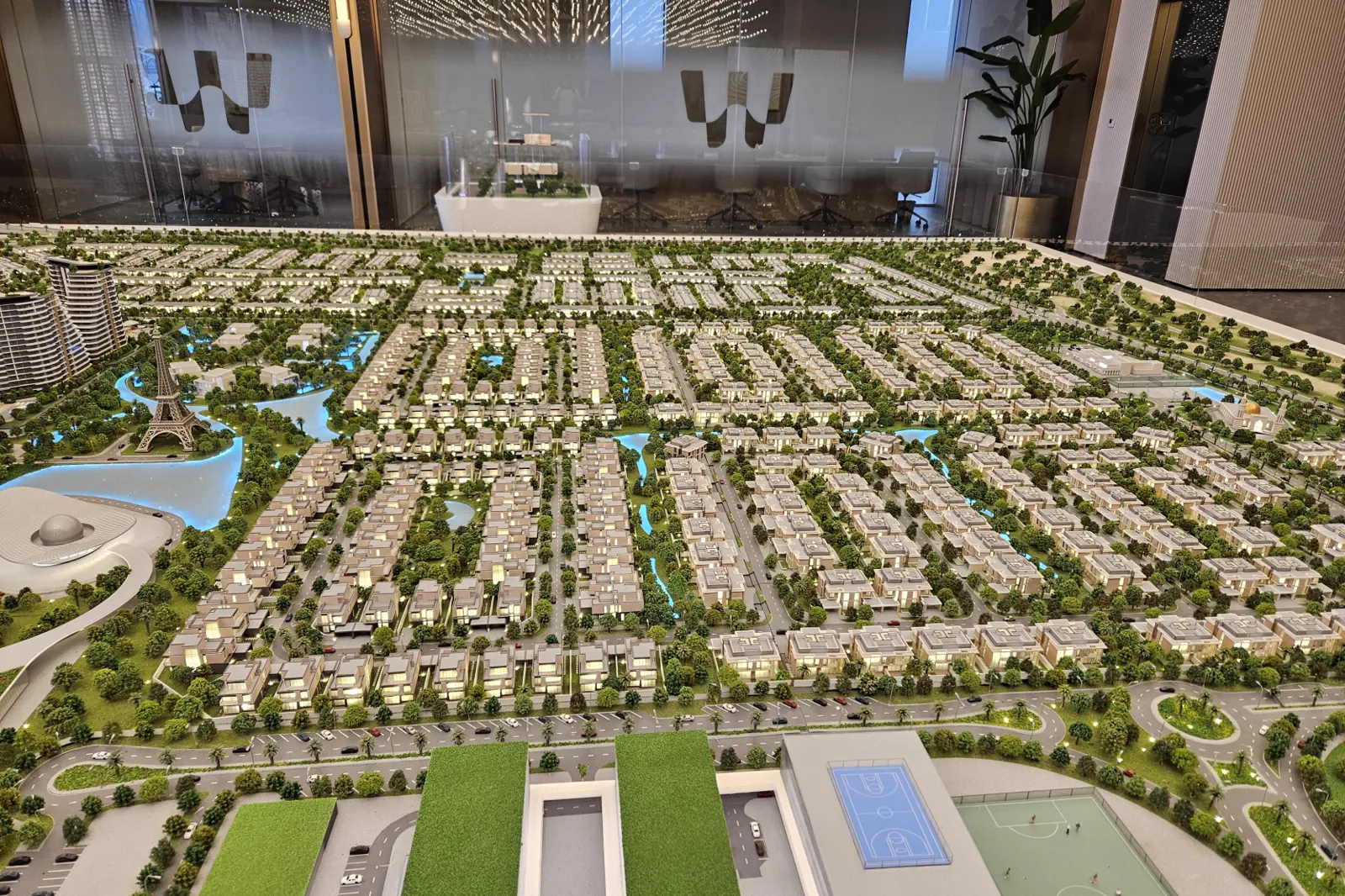 Waada masterplan model photographed on Propsearch — villa streets, Eiffel replica and mosque around a lake