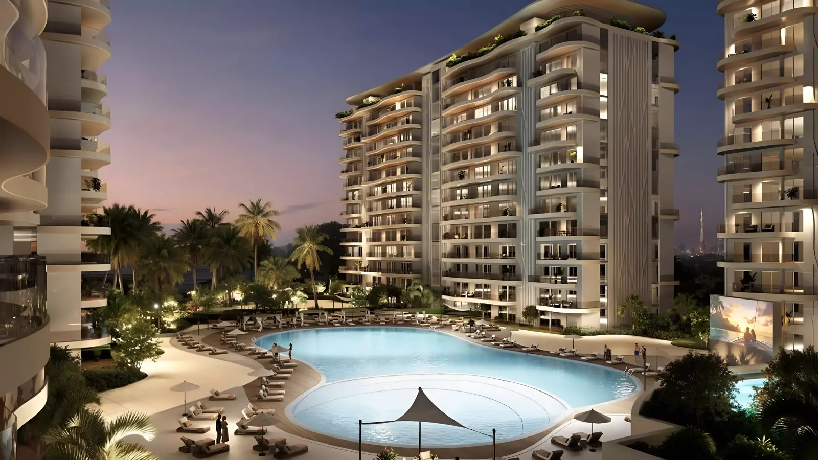 Valencia at DAMAC Lagoons — dusk marketing courtyard pool framed by illuminated apartment façades